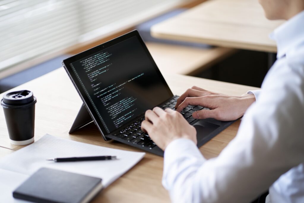 man using computer in cafe